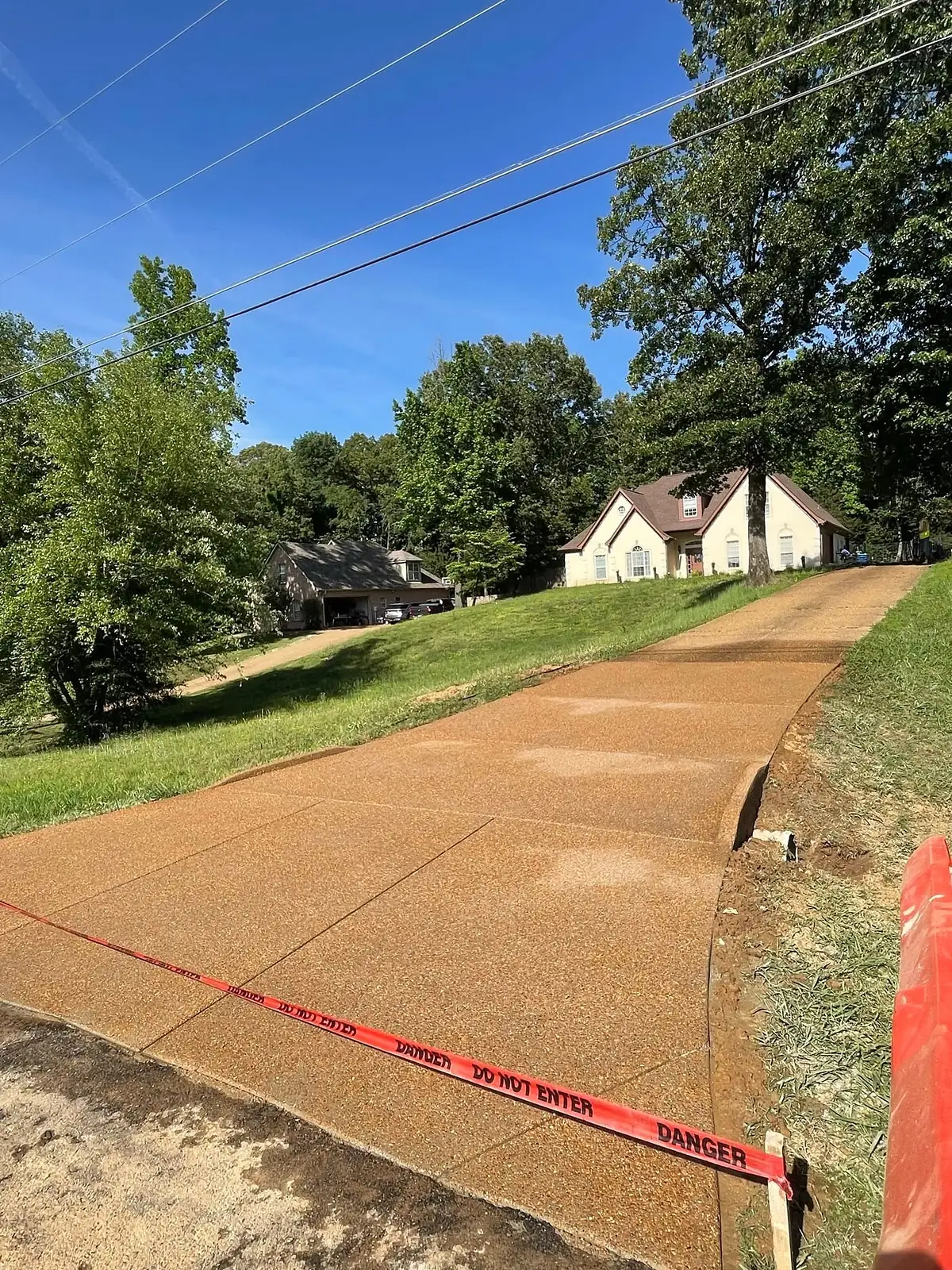 Exposed aggregate driveway taped off while it cures