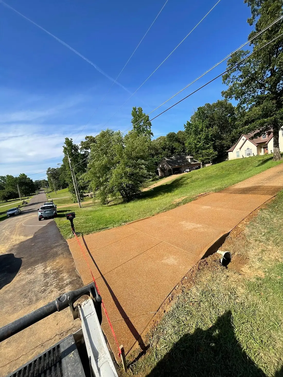 Wide exposed aggregate driveway seen from the truck at the curb