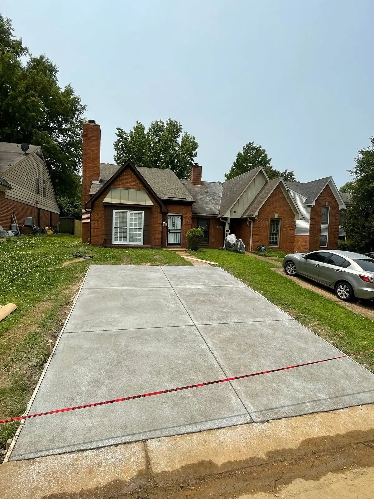 Bright new concrete driveway with evenly spaced control joints