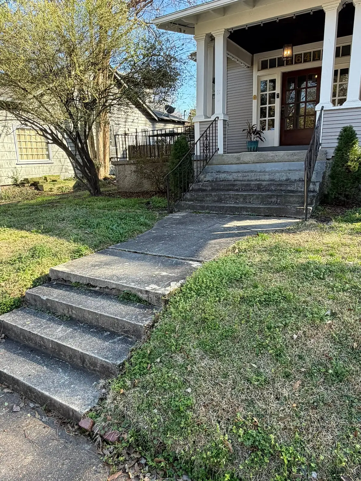 Cracked narrow walkway and worn concrete steps before replacement