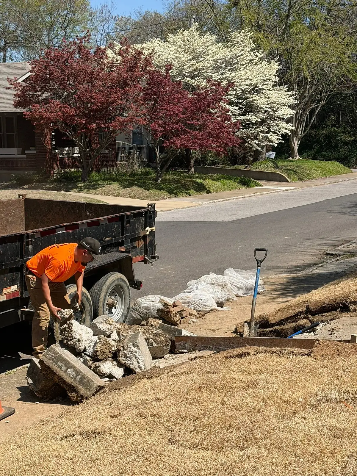 Broken concrete being loaded into a dump trailer for haul away