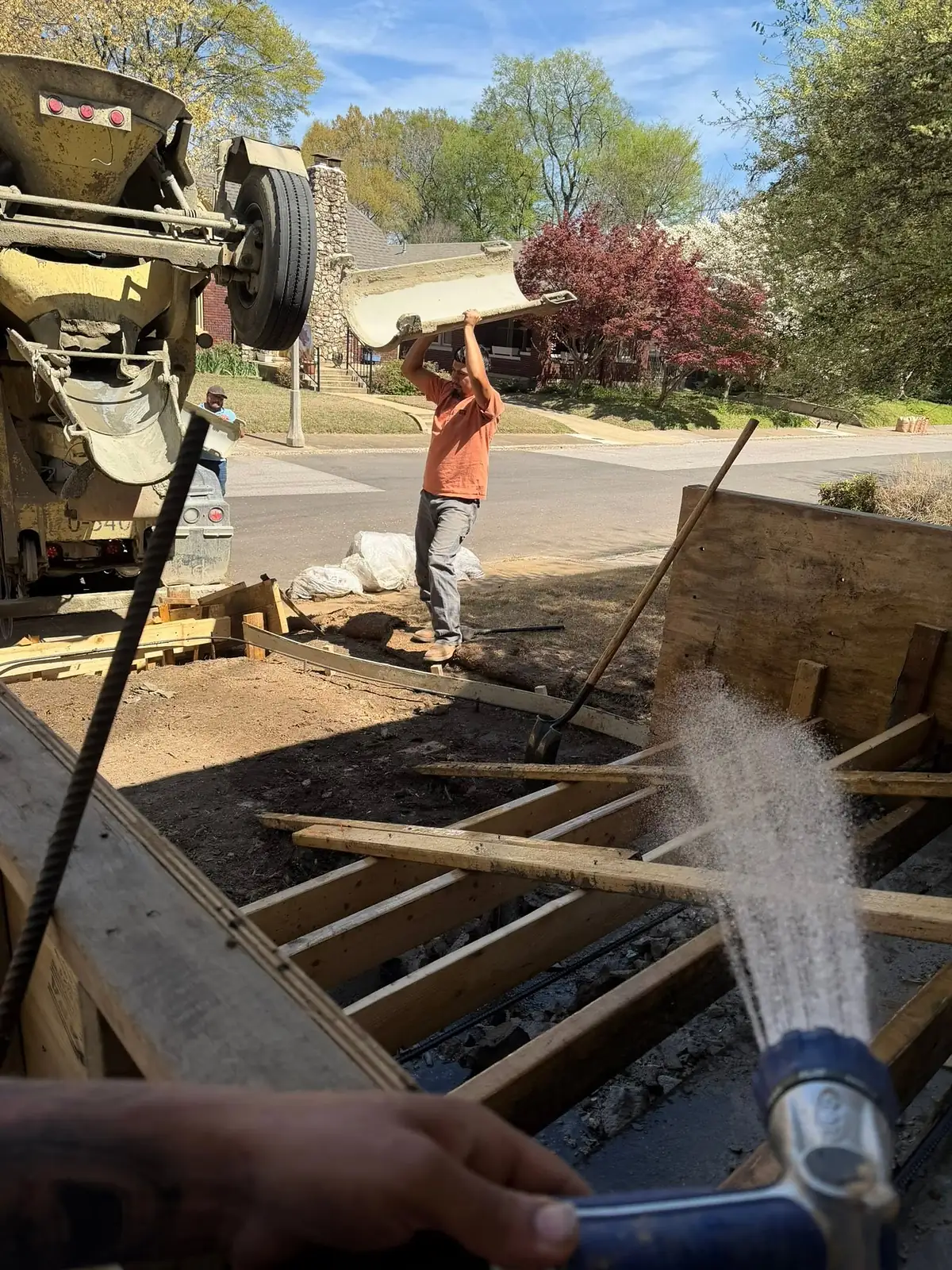 Concrete running down a mixer truck chute into the step forms