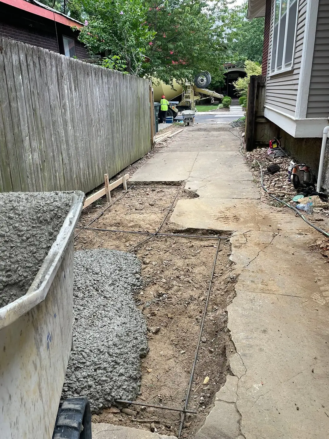 Concrete buggy loaded with mix ready to place in a tight side yard