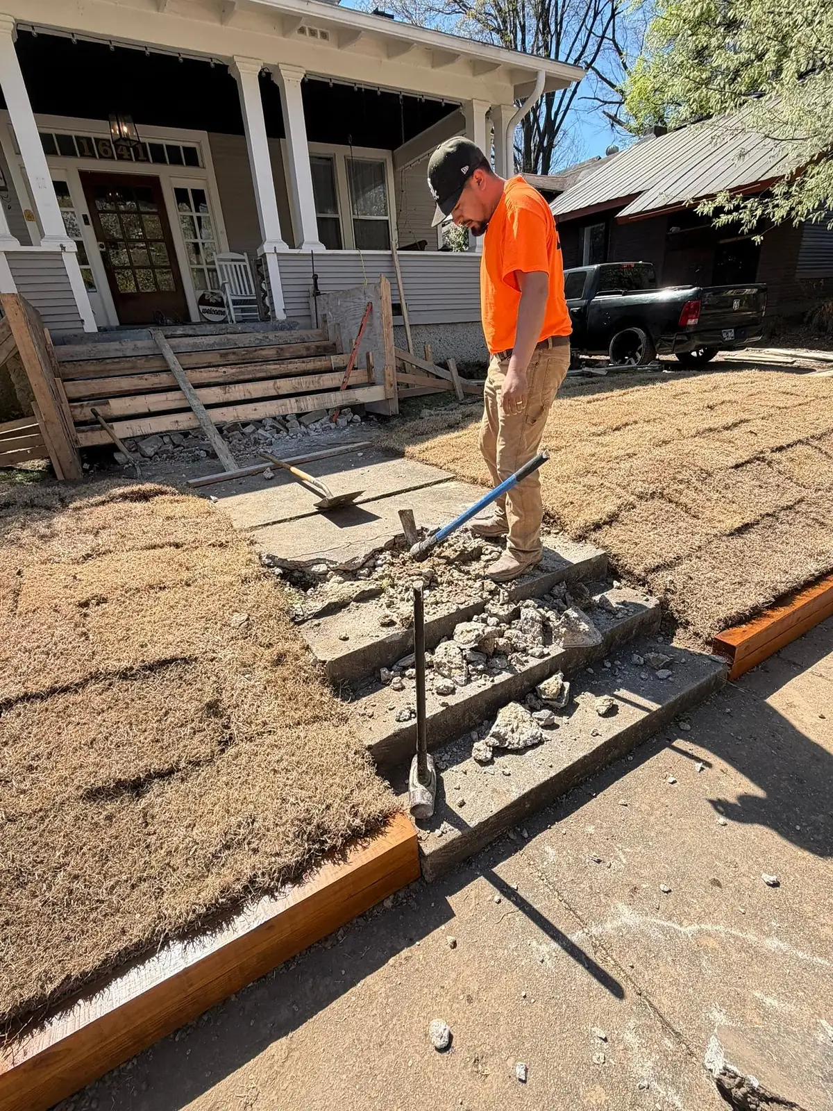 KRS Concrete worker breaking out the old front steps of a bungalow