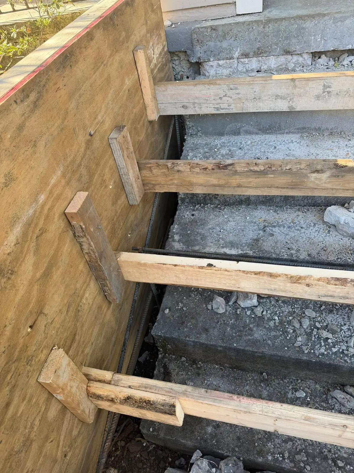 Timber step forms braced over a compacted gravel base