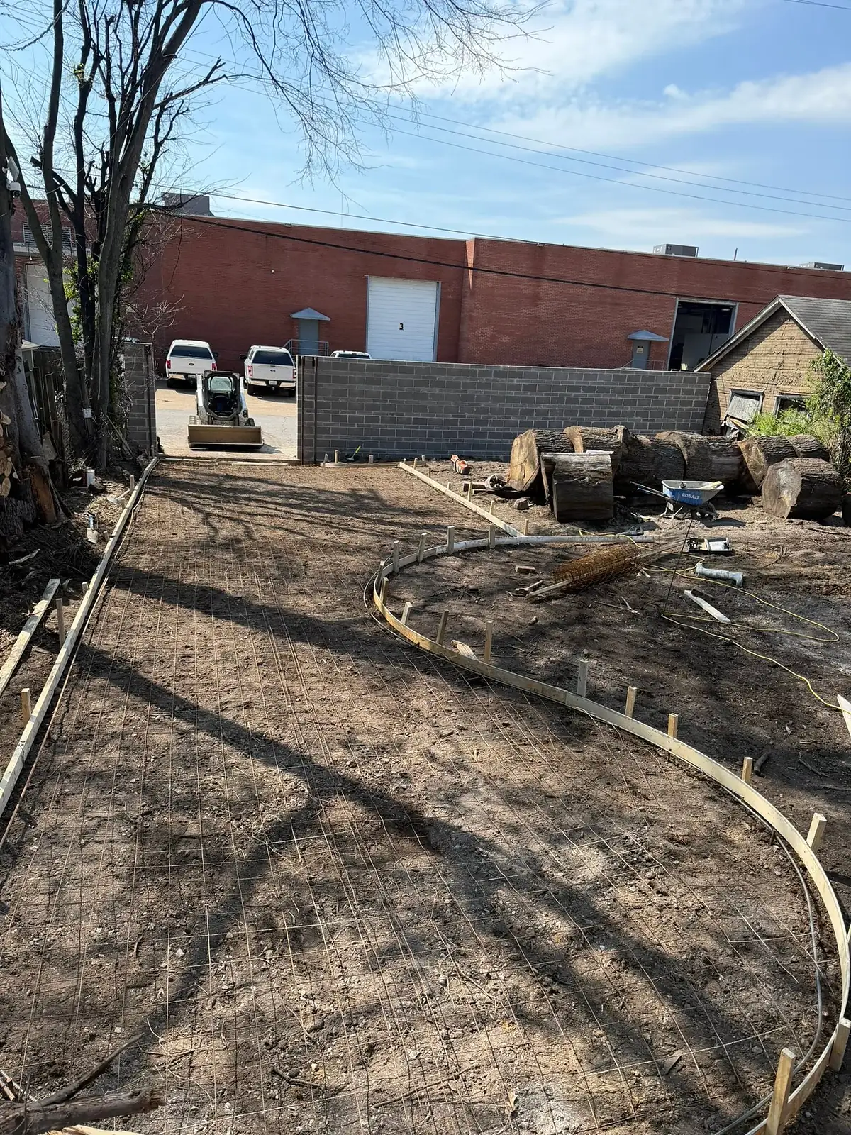 Graded soil and timber forms laid out for a new city walkway