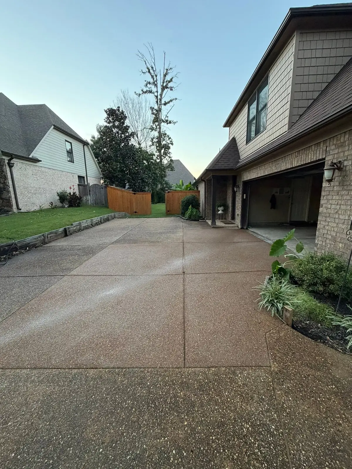 Exposed aggregate wash finish driveway leading to a two-car garage
